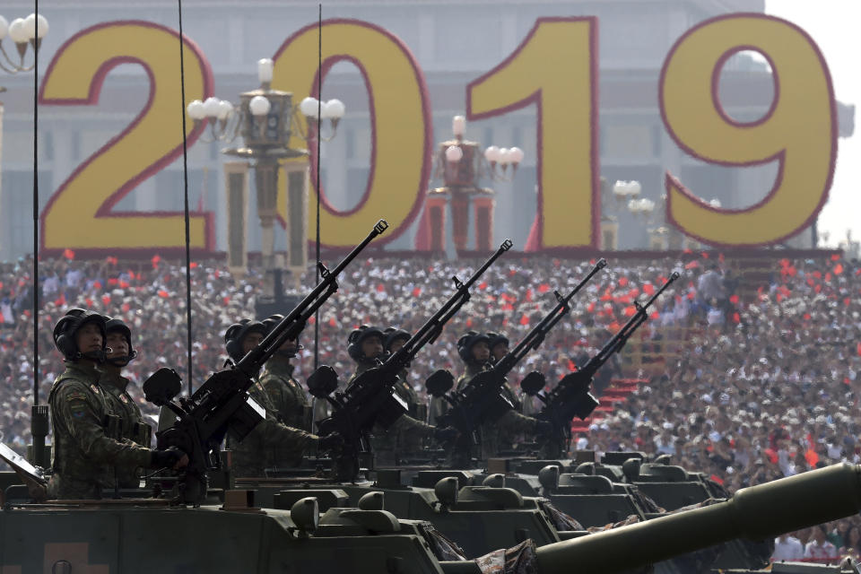 Army vehicles roll down during a parade to commemorate the 70th anniversary of the founding of Communist China in Beijing, Tuesday, Oct. 1, 2019. (AP Photo/Ng Han Guan)