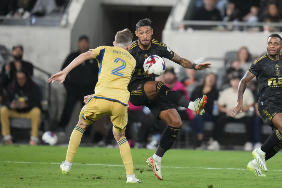 Los Angeles FC forward Denis Bouanga, center right, is pressured by Real Salt Lake defender Andrew Brody (2) during the second half of an MLS soccer match Sunday, Oct. 1, 2023, in Los Angeles. (AP Photo/Jae C. Hong)