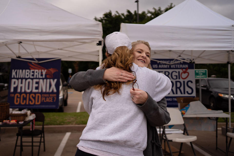 Image: Kimberly Phoenix hugs an acquaintance outside a voting location at Grapevine Library in Texas.
 (Danielle Villasana for NBC News)