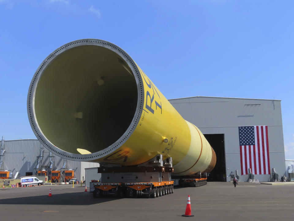 A giant monopile, the foundation for an offshore wind turbine, sits on rollers at the Paulsboro Marine Terminal in Paulsboro, N.J. on Thursday, July 6, 2023, when New Jersey Gov. Phil Murphy planned to sign a bill granting a tax break to offshore wind developer Orsted. (AP Photo/Wayne Parry)