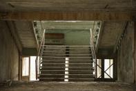 <p>A stairwell stands in abandoned elementary school (Getty Images) </p>