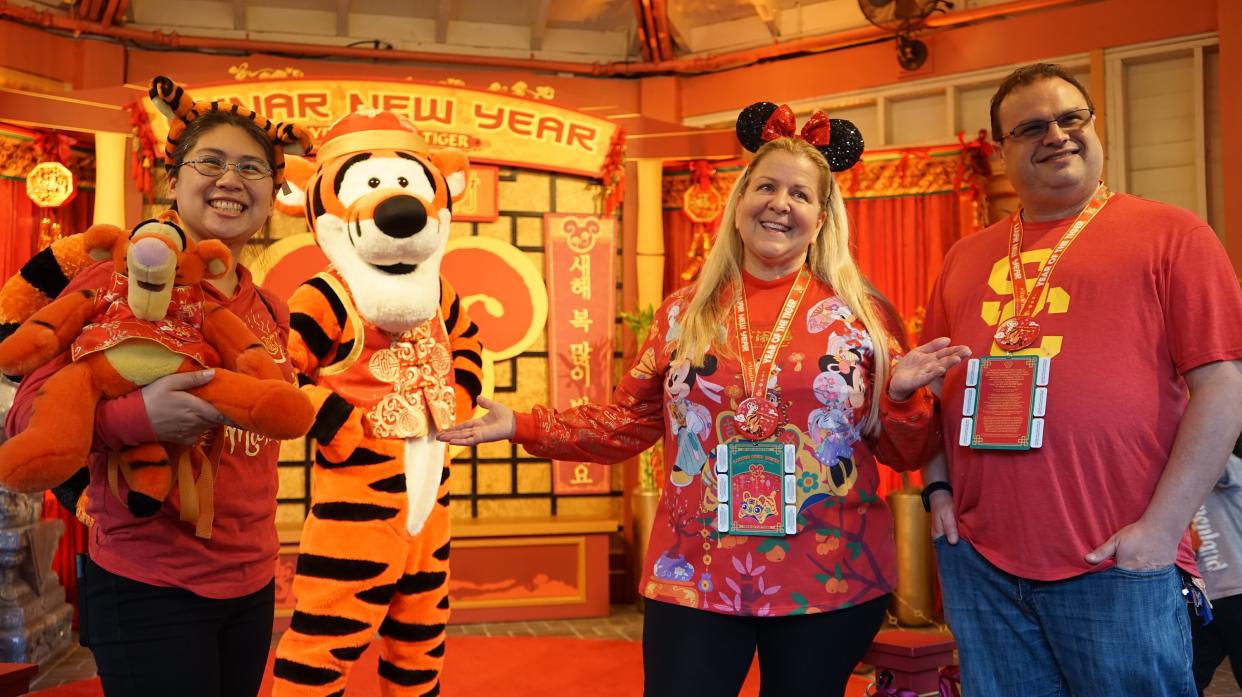 220122 -- ANAHEIM U.S., Jan. 22, 2022 Xinhua -- Visitors pose for photos with the cartoon character Tigger during the Lunar New Year celebrations at Disney's California Adventure Park in Anaheim, the United States, on Jan. 21, 2022. Disney's California Adventure Park kicked off celebrations of the Year of the Tiger Friday, featuring a string of Chinese culturally-themed performances, art shows, lantern decorations and Asian-inspired dishes. (Photo by Zeng Hui/Xinhua via Getty Images) TO GO WITH Feature: Disneyland celebrates Chinese Lunar New Year with dynamic cultural activities