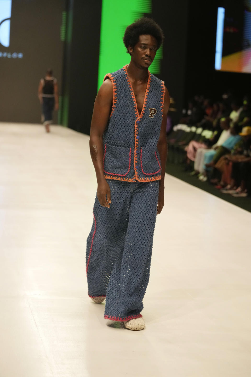 A model wears a creation by Pettre Tylor during the Lagos Fashion Week in Lagos, Nigeria, Thursday, Oct. 26, 2023. Africa's fashion industry is rapidly growing to meet local and international demands but a lack of adequate investment still limits its full potential, UNESCO said Thursday in its new report released at this year's Lagos Fashion Week show. (AP Photo/Sunday Alamba)