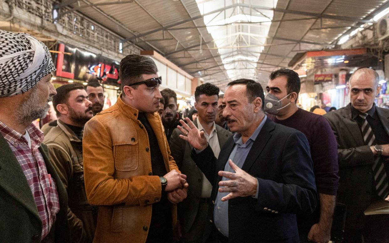 Governor Najim al-Jabouri (R) talks to Mosul residents in the Nabi Yunus market - Sam Tarling 