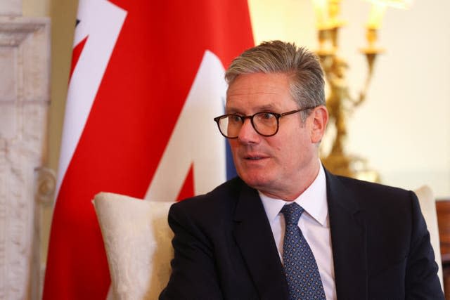 Sir Keir Starmer sitting in front of a Union flag