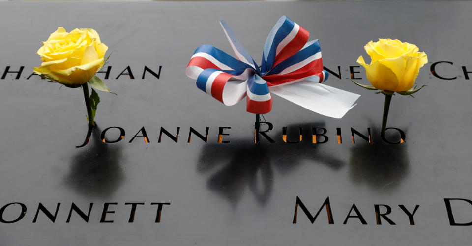 <p>A ribbon and roses are placed on one of the victims’ name at the north reflecting pool at the National 9/11 Memorial, during ceremonies marking the 17th anniversary of the September 11, 2001 attacks on the World Trade Center, at the National 9/11 Memorial and Museum in New York, Sept.11, 2018. (Photo: Brendan McDermid/Reuters) </p>