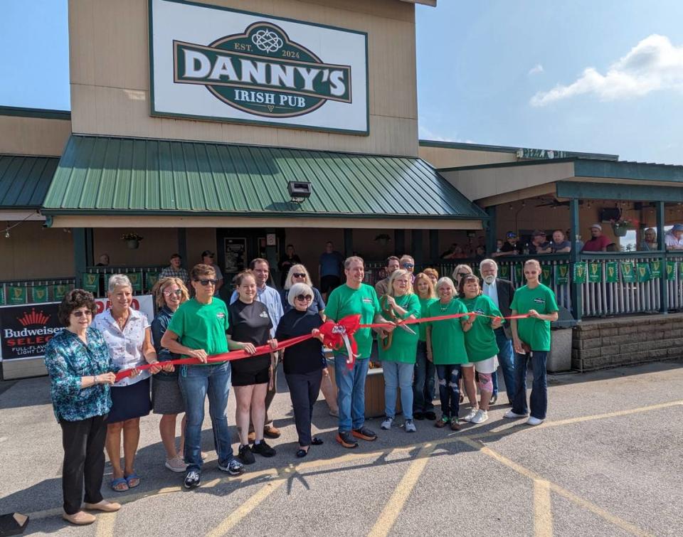 Marty and Becky Phelps (center) celebrate the grand opening of their new business, Danny’s Irish Pub and Banquet Center.