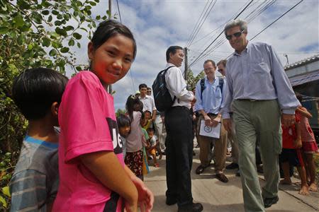 U.S. Secretary of State John Kerry (R) visits the village of Kien Vang along the Mekong River Delta December 15, 2013. REUTERS/Brian Snyder