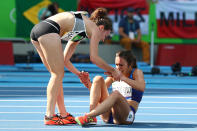<p>Abbey D’Agostino of the United States (R) is assisted by Nikki Hamblin of New Zealand after a collision during the Women’s 5000m Round 1 – Heat 2 on Day 11 of the Rio 2016 Olympic Games at the Olympic Stadium on August 16, 2016 in Rio de Janeiro, Brazil. (Photo by Ian Walton/Getty Images) </p>