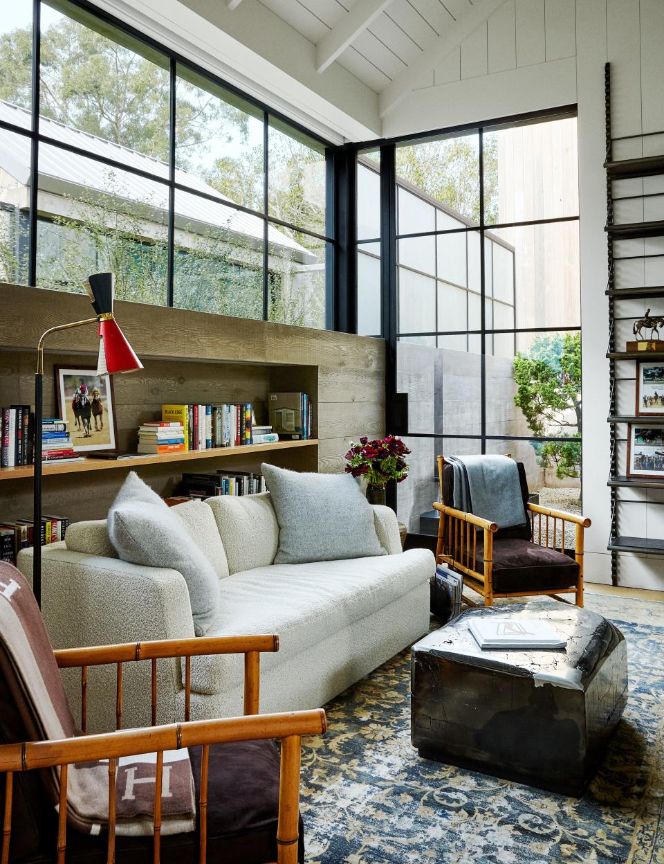 Barry's office seating area features a Bouclé-covered sofa, bamboo chairs, and a cocktail table by Jimi Zivic Design from Ralph Pucci. 1960's Angelo Lelli floor lamp.