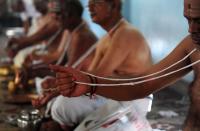 <p>A Indian Hindu Brahmin community holds a newly worn sacred thread they wear across their bodies as they perform an annual ritual on the occasion of ‘Aavani Avittam’ in Chennai on August 18,2016. Members of the Hindu Brahmin community change the sacred thread they wear across their bodies as part of ritual of ‘Aavani Avittam’ </p>