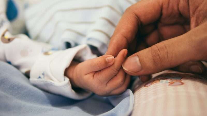 Mother holding baby's hand