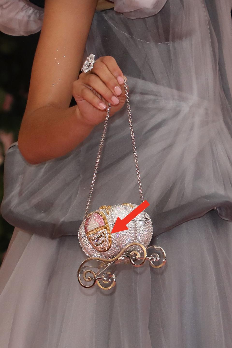 Zendaya holding a sparkling pumpkin carriage-shaped purse at the Met Gala