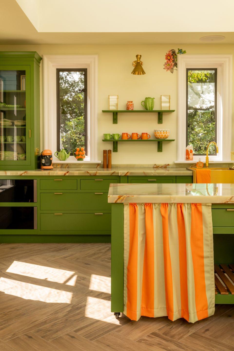 a green kitchen with colourful fabric trims