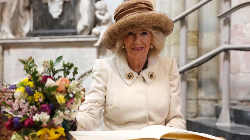 The Queen accessorised with Queen Elizabeth's gold and sapphire brooches