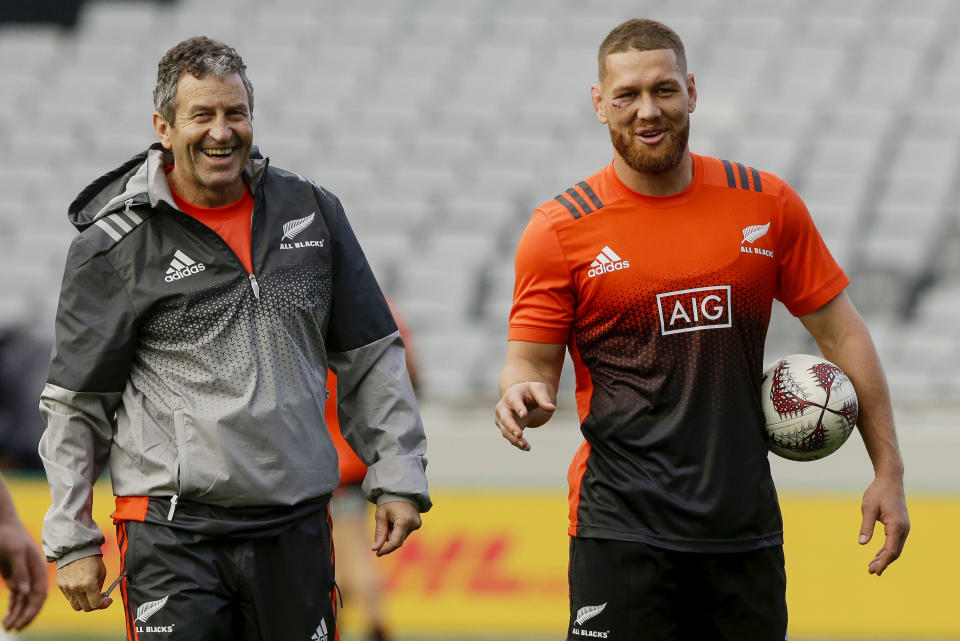 FILE - All Blacks assistant coach Wayne Smith, left, jokes with All Black Tawera Kerr Barlow during the captain's run at Eden Park in Auckland, New Zealand, June 23, 2017. Women's World Cup-winning coach Smith received a knighthood, Monday, June 5, 2023, for services to rugby in New Zealand's annual King's birthday honors. (AP Photo/Mark Baker, File)