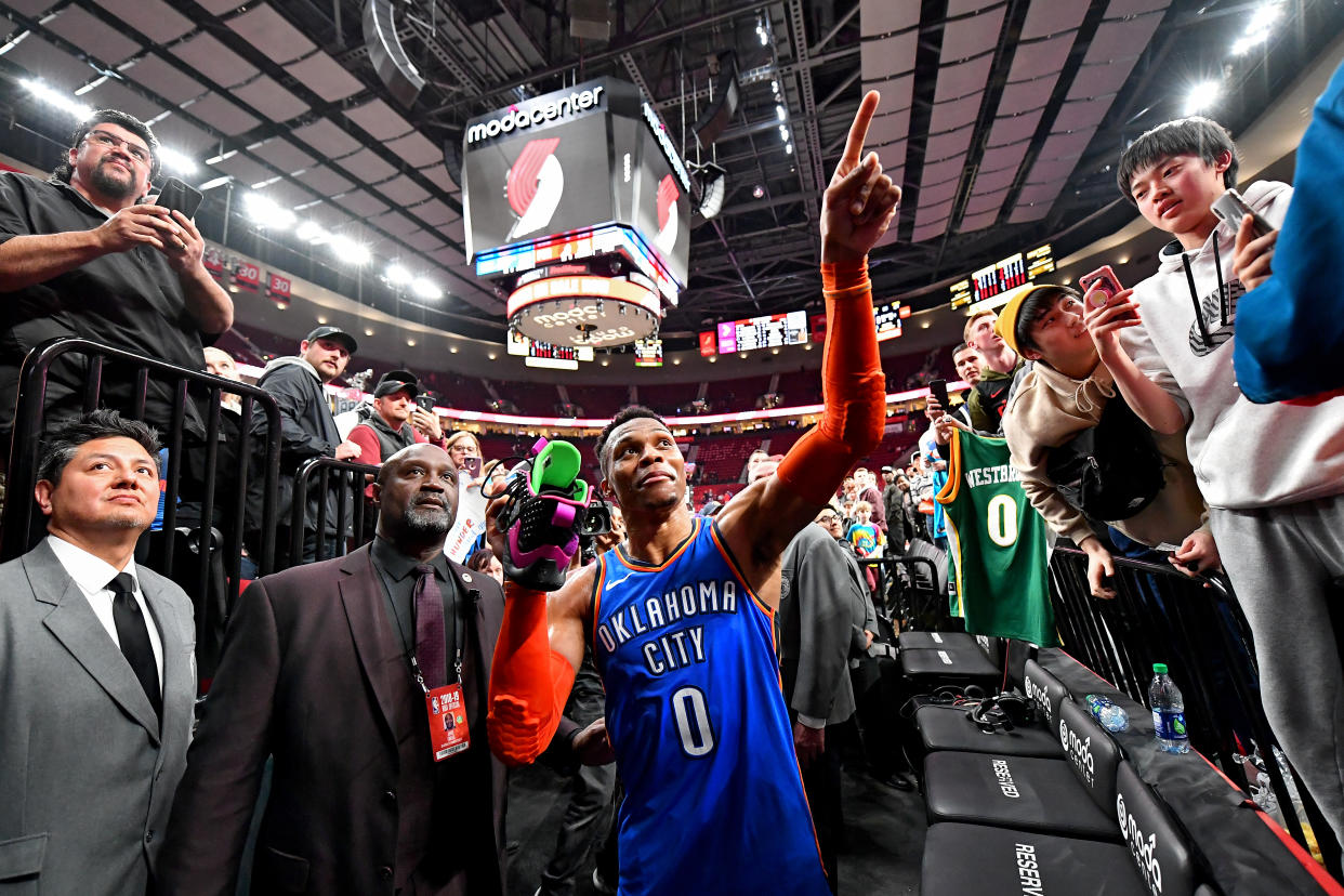 PORTLAND, OREGON - MARCH 07:  At the end of the game against the Portland Trail Blazers, Russell Westbrook #0 of the Oklahoma City Thunder tosses a shoe to a fan at the Moda Center on March 07, 2019 in Portland, Oregon. The Oklahoma City Thunder won in overtime 129-121. NOTE TO USER: User expressly acknowledges and agrees that, by downloading and or using this photograph, User is consenting to the terms and conditions of the Getty Images License Agreement. (Photo by Alika Jenner/Getty Images)