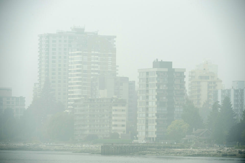 FILE - In this Monday, Sept. 14, 2020 file photo, Buildings in West Vancouver, British Columbia, Canada are obscured due to the heavy smoke in the air from the wildfires burning south of the border. On Friday, Sept. 18, 2020, The Associated Press reported on stories circulating online incorrectly asserting maps of recent wildfires in the Pacific Northwest show the fires stop abruptly at the Canadian border. Maps circulating on social media with this claim include only American data. Canada has its own fire mapping system, which shows there are fires burning in British Columbia, just north of the western U.S. (Jonathan Hayward/The Canadian Press via AP)