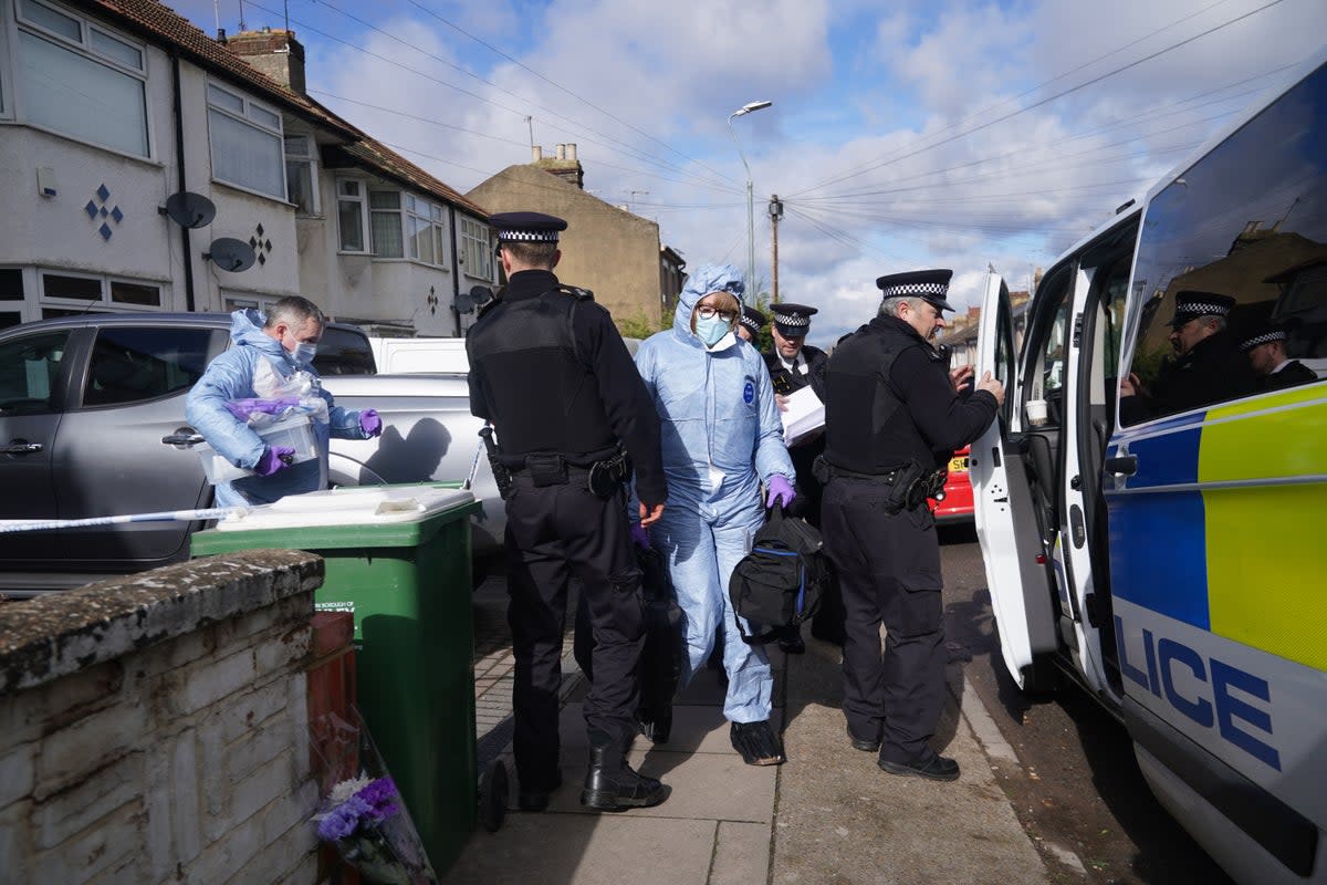 Police forensics officers leave a property on Mayfield Road in Belvedere, south London, where a 47-year-old woman and two boys, aged nine and seven, have been found dead (PA)