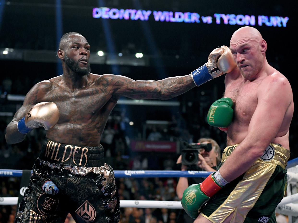 Deontay Wilder punches Tyson Fury in their first fight in 2018 (Getty Images)