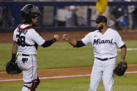 Miami Marlins catcher Jorge Alfaro, left, and relief pitcher Yimi Garcia congratulate each other after the Marlins beat the Philadelphia Phillies 4-2 in a baseball game, Wednesday, May 26, 2021, in Miami. (AP Photo/Wilfredo Lee)