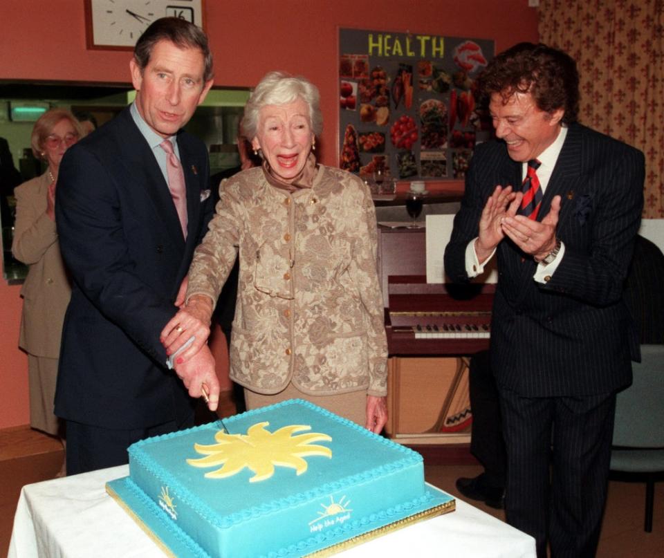 Lionel Blair applauds as the Prince of Wales helps veteran actress Jean Anderson as she cuts the cake to celebrate her 90th birthday (Alan Weller/PA) (PA Archive)