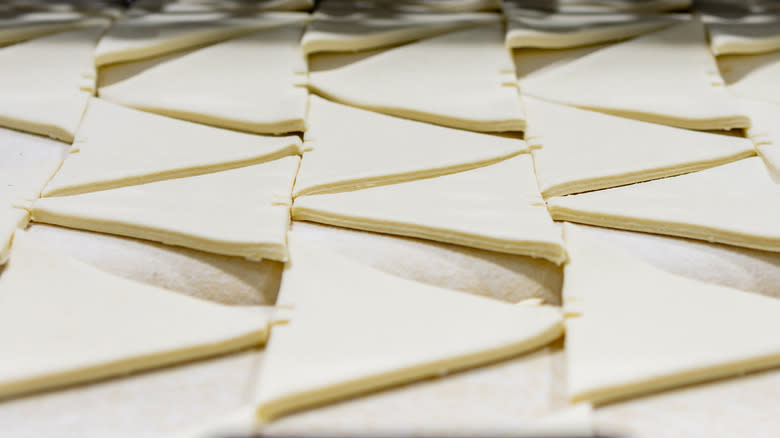 Triangles of puff pastry dough