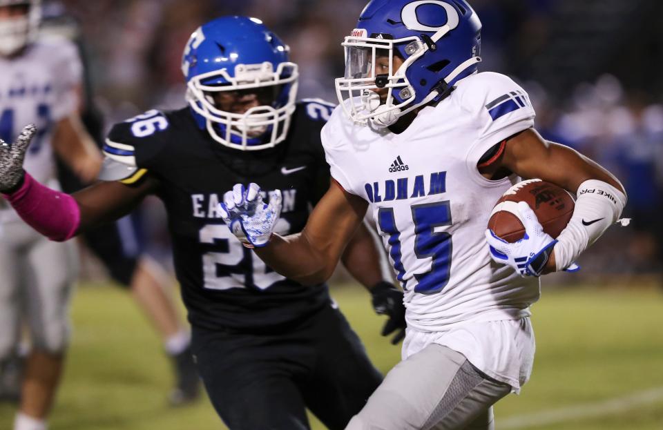 Oldham County’s Justin Ruffin (15) gains yardage against an Eastern defender during their game at the Eastern High School in Louisville, Ky. on Sep. 30, 2021.