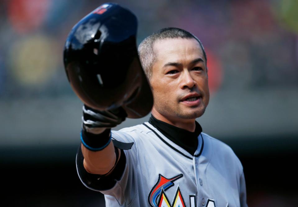 Ichiro Suzuki tips his batting helmet to the crowd as fans applaud after his triple Aug. 7, 2016 in Denver. The hit was the 3,000th in his MLB career.