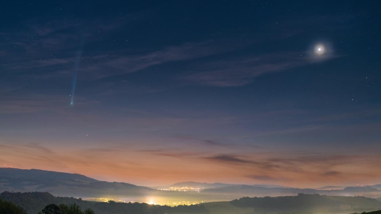  A sunrise with a comet in the sky. 