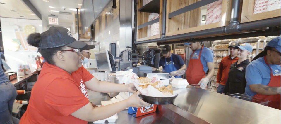 Raising Cane&#39;s employees serving guests (Courtesy: Raising Cane&#39;s) 