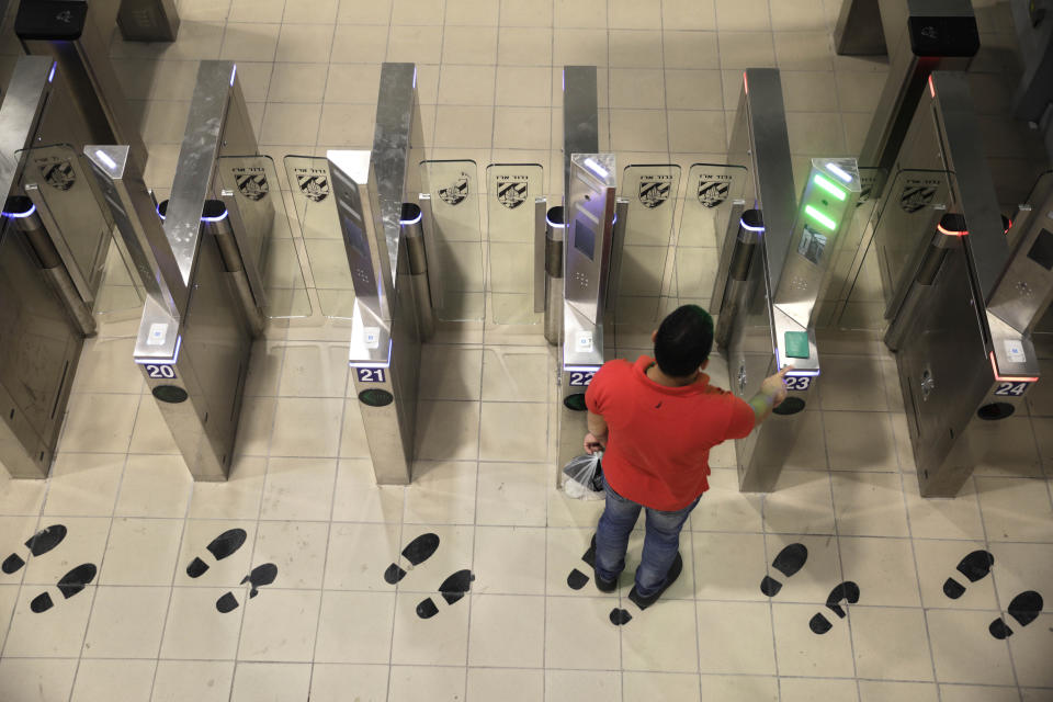 In this Thursday, July 11, 2019 photo, a Palestinian man uses a biometric gate as he crosses into Israel at the Qalandia crossing in Jerusalem. Israel’s military has invested tens of millions of dollars to upgrade West Bank crossings and ease entry for Palestinian workers. But while the upgrades may have eased crossing for Palestinians entering Israeli daily for work, critics say they are a sign of the ossification of Israel’s 52-year occupation of the West Bank and slam the military’s use of facial recognition technology as problematic. (AP Photo/Sebastian Scheiner)