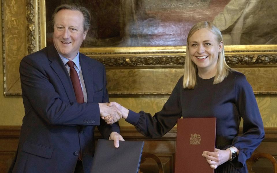 Lord Cameron, the Foreign Secretary, shakes hands with Finland's Foreign Minister Elina Valtonen