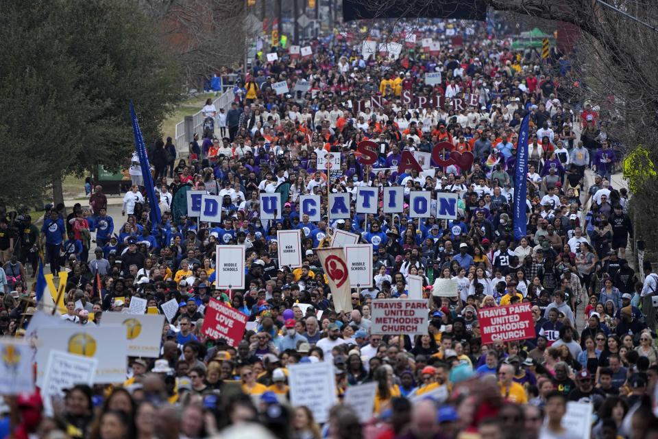 Thousands of walkers take part in a march honoring Martin Luther King Jr. in San Antonio, Monday, Jan. 16, 2023. (AP Photo/Eric Gay)