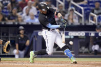 Miami Marlins' Miguel Rojas hits a single during the fifth inning of a baseball game against the San Diego Padres, Saturday, July 24, 2021, in Miami. (AP Photo/Lynne Sladky)