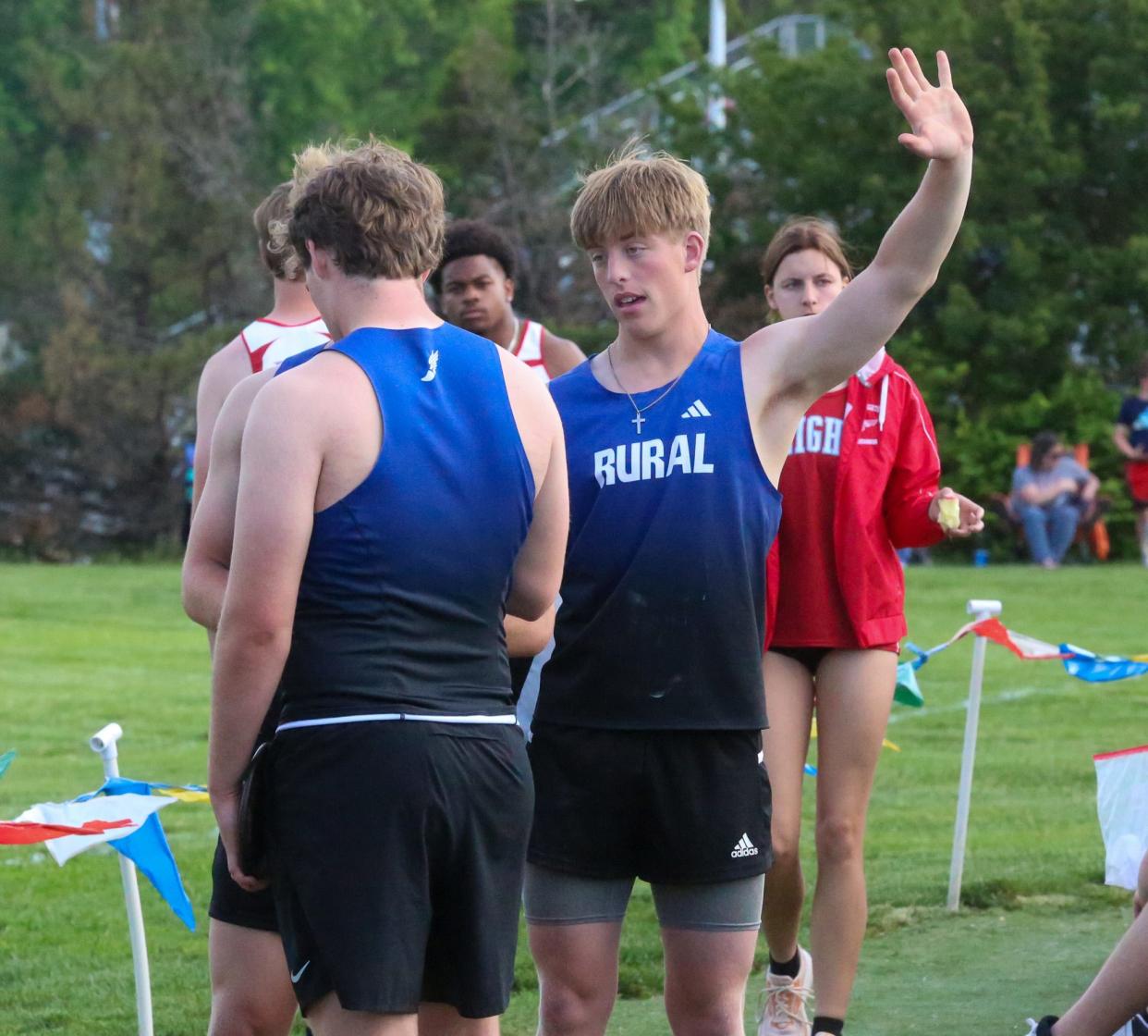 Washburn Rural's Josh Sulzen-Watson chats with his teammates about form during the Joe Schrag City Meet on Friday, May 3.