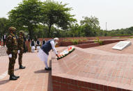 In this photo provided by Prime Minister of India Narendra Modi's twitter handle, Indian Prime Minister Narendra Modi places a floral wreath at the National Martyrs' Memorial in Dhaka, Bangladesh, Friday, March 26, 2021. Modi arrived in Bangladesh’s capital on Friday to join celebrations marking 50 years of the country's independence, but his trip was not welcomed by all. The two-day visit, his first foreign trip since the coronavirus pandemic began last year, will also include joining commemorations for 100 years since the birth of independence leader Sheikh Mujibur Rahman, the father of current Prime Minister Sheikh Hasina. (Prime Minister of India Narendra Modi's twitter handle via AP Photo)