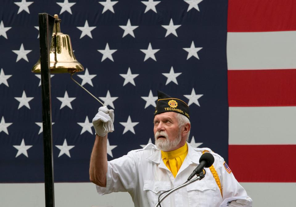 Veterans of Foreign Wars member Tim Scheurer rings the bell honoring fallen war veterans May 31, 2021, during Tecumseh's Memorial Day ceremony at Brookside Cemetery.