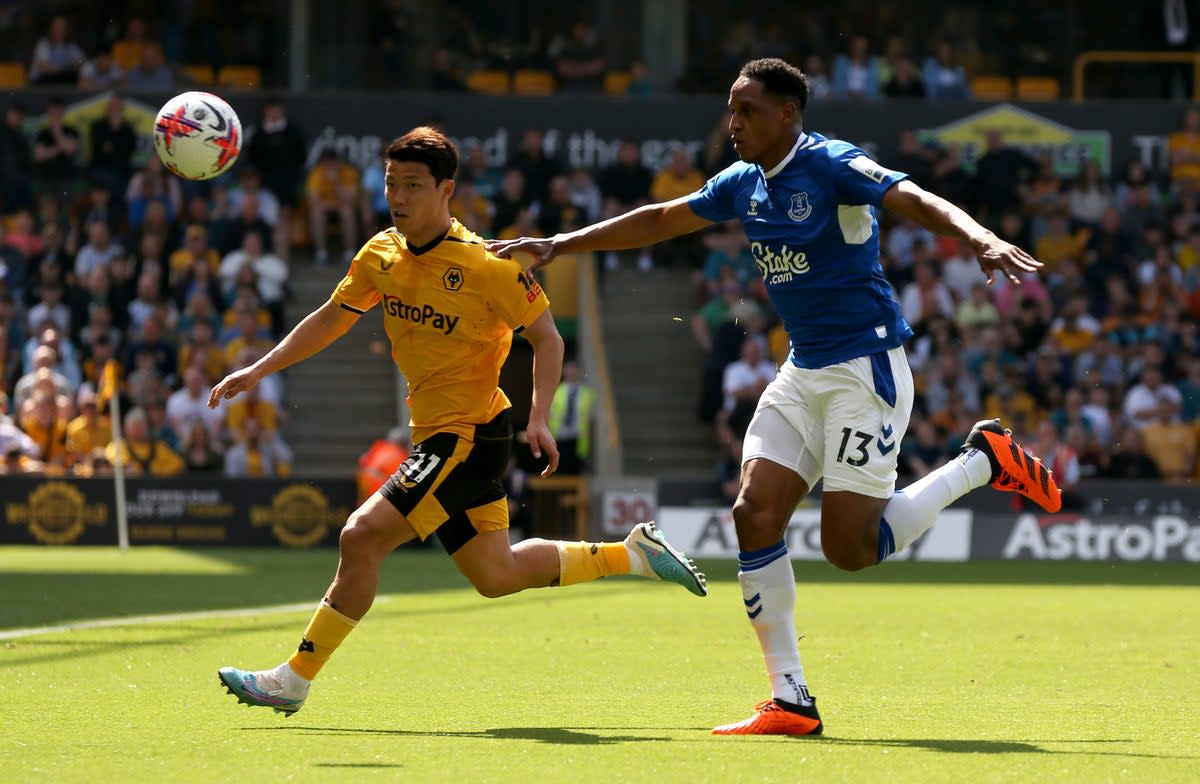 Hwang Hee-Chan battles with Yerry Mina for the ball (PA)