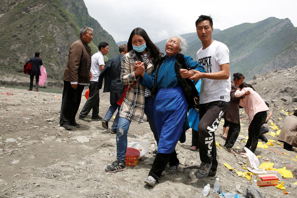 <p>Relatives of victims react at the site of a landslide in the village of Xinmo, Mao County, Sichuan Province, China, June 26, 2017. (Photo: Aly Song/Reuters) </p>