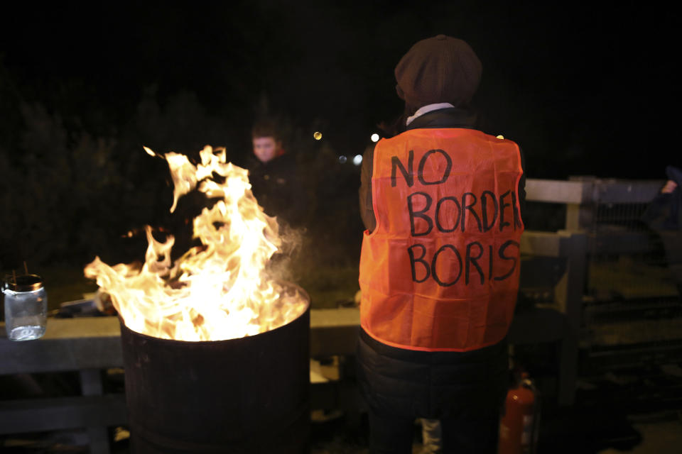 Protesters from the Border Communities Against Brexit group hold a demonstration on the Irish border on the Republic of Ireland side close to the town of Jonesborough, Ireland, Wednesday, Oct. 16 , 2019. The Border Communities Against Brexit group organised various protests at many points across the border region Wednesday. (AP Photo/Peter Morrison)