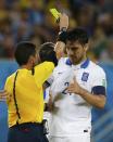 Greece's Kostas Katsouranis (R) is shown a yellow card by referee Joel Aguilar of El Salvador during their 2014 World Cup Group C soccer match against Japan at the Dunas arena in Natal June 19, 2014. REUTERS/Toru Hanai