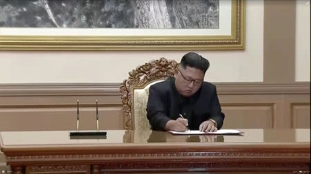 North Korean leader Kim Jong Un signs documents during the inter-Korean summit at the Paekhwawon State Guesthouse in Pyongyang, North Korea in this still frame taken from video September 19, 2018. KBS/via REUTERS TV