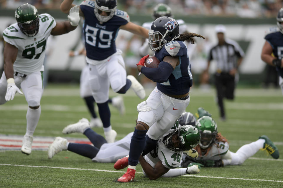 Tennessee Titans running back Derrick Henry (22) is tackled by New York Jets cornerback Javelin Guidry (40) during the second half of an NFL football game, Sunday, Oct. 3, 2021, in East Rutherford, N.J. (AP Photo/Bill Kostroun)