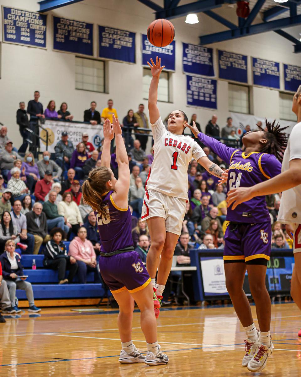 Kailah Correa (1) attempts to lay one in, but Mary Bolesky (20) draws a charging foul. The Lancaster Catholic Crusaders faced the Lebanon Cedars in the LL League Girls Championship on February 15, 2024 at Manheim Township. The Crusaders took the title defeating the Cedars 62-48.