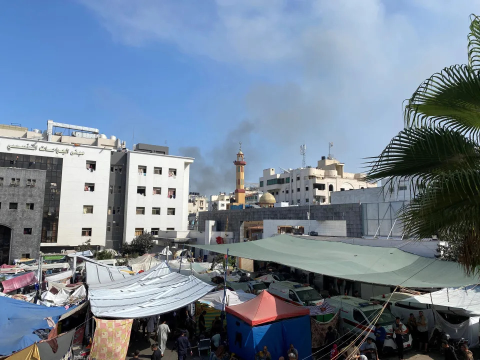Smoke rises as displaced Palestinians take shelter at Al Shifa hospital in Gaza City on Nov. 9. (Doaa Rouqa/Reuters)