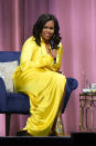 <p>Michelle Obama spoke about new book in a sunshine yellow split dress with Balenciaga’s $4,000 thigh-high sparkly boots to finish. Now, you can’t get more festive than that… <em>[Photo: Getty]</em> </p>