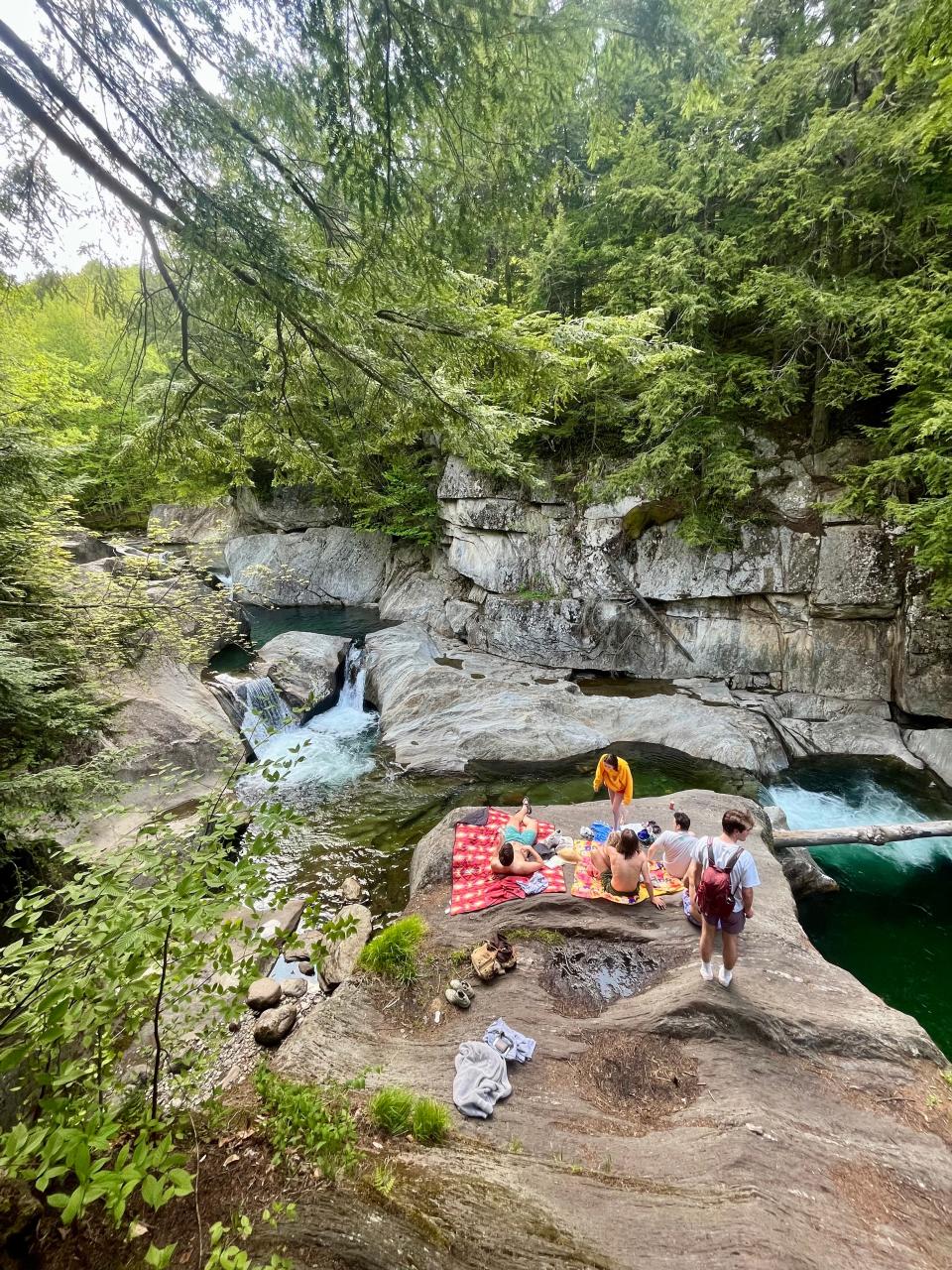 A group of students hanging out at Warren Falls.