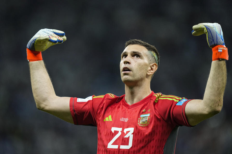 Argentina's goalkeeper Emiliano Martinez celebrates at the end of the World Cup quarterfinal soccer match between the Netherlands and Argentina, at the Lusail Stadium in Lusail, Qatar, Saturday, Dec. 10, 2022. Argentina defeated the Netherlands 4-3 in a penalty shootout after the match ended tied 2-2.(AP Photo/Jorge Saenz)