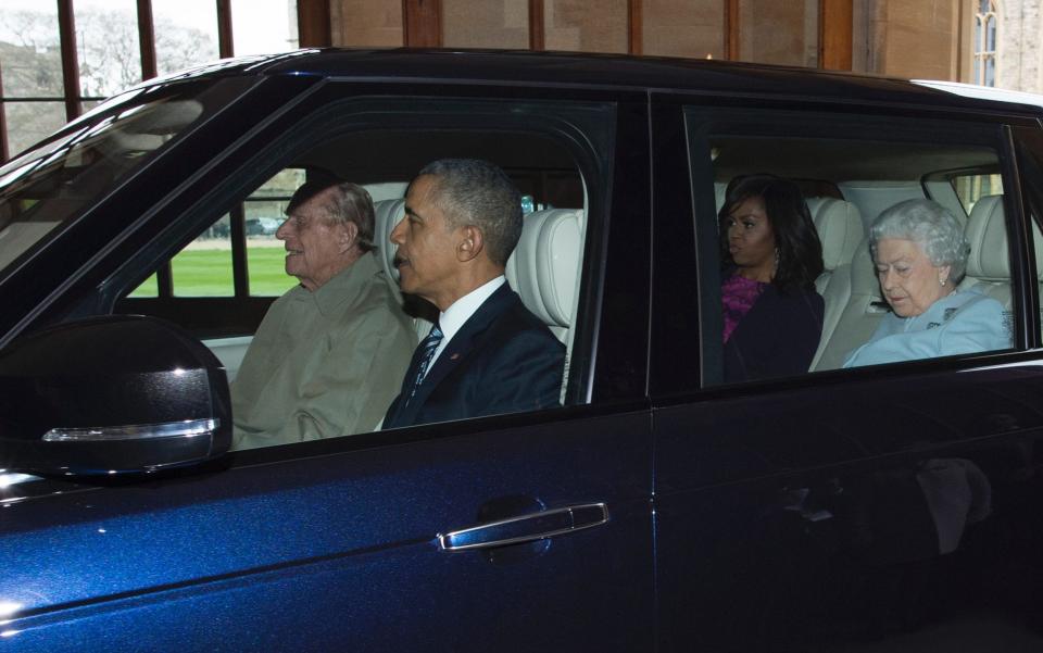 The late Duke of Edinburgh driving former US president Barack Obama and former US first lady Michelle Obama in 2016 - GEOFF PUGH/AFP